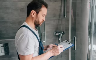plumber inspecting a homeowners bathroom