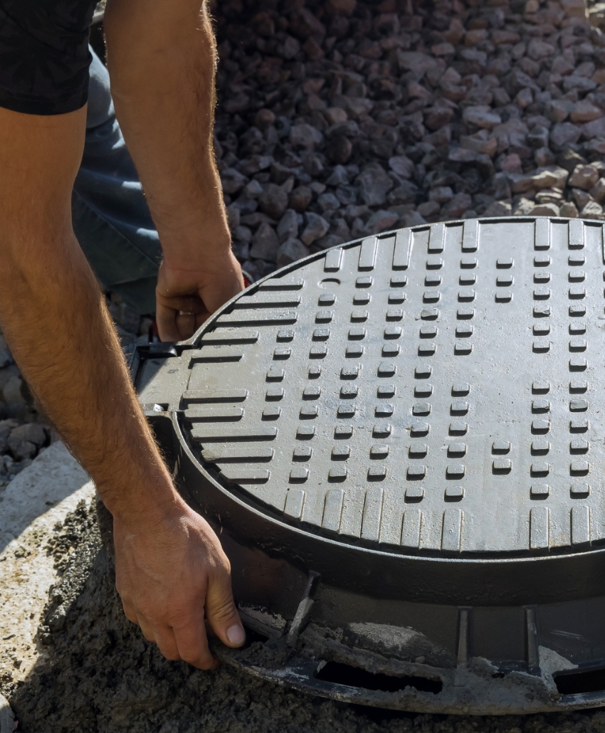A person working on a residential sewer system.