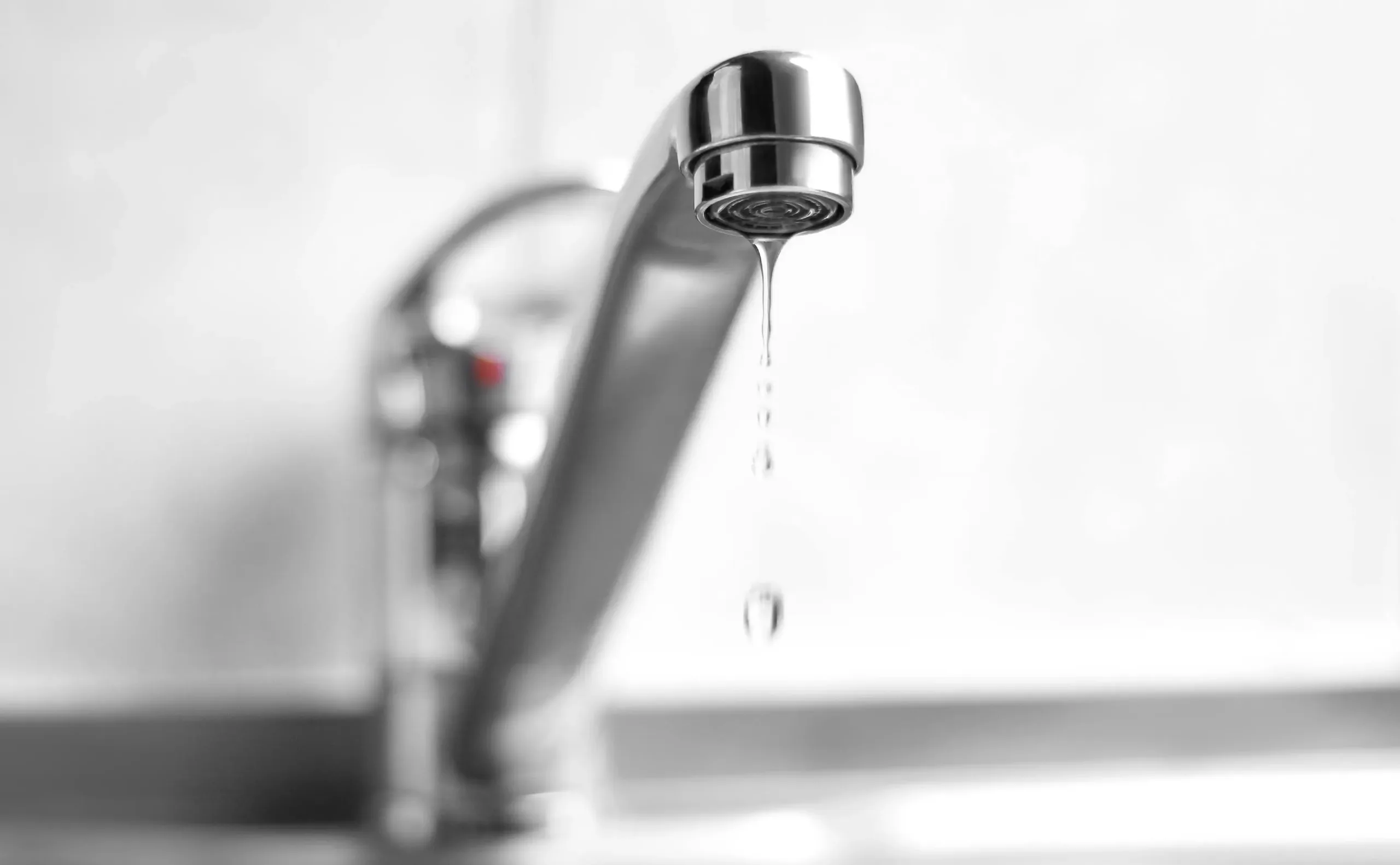 Silver dripping kitchen or bathroom faucet.