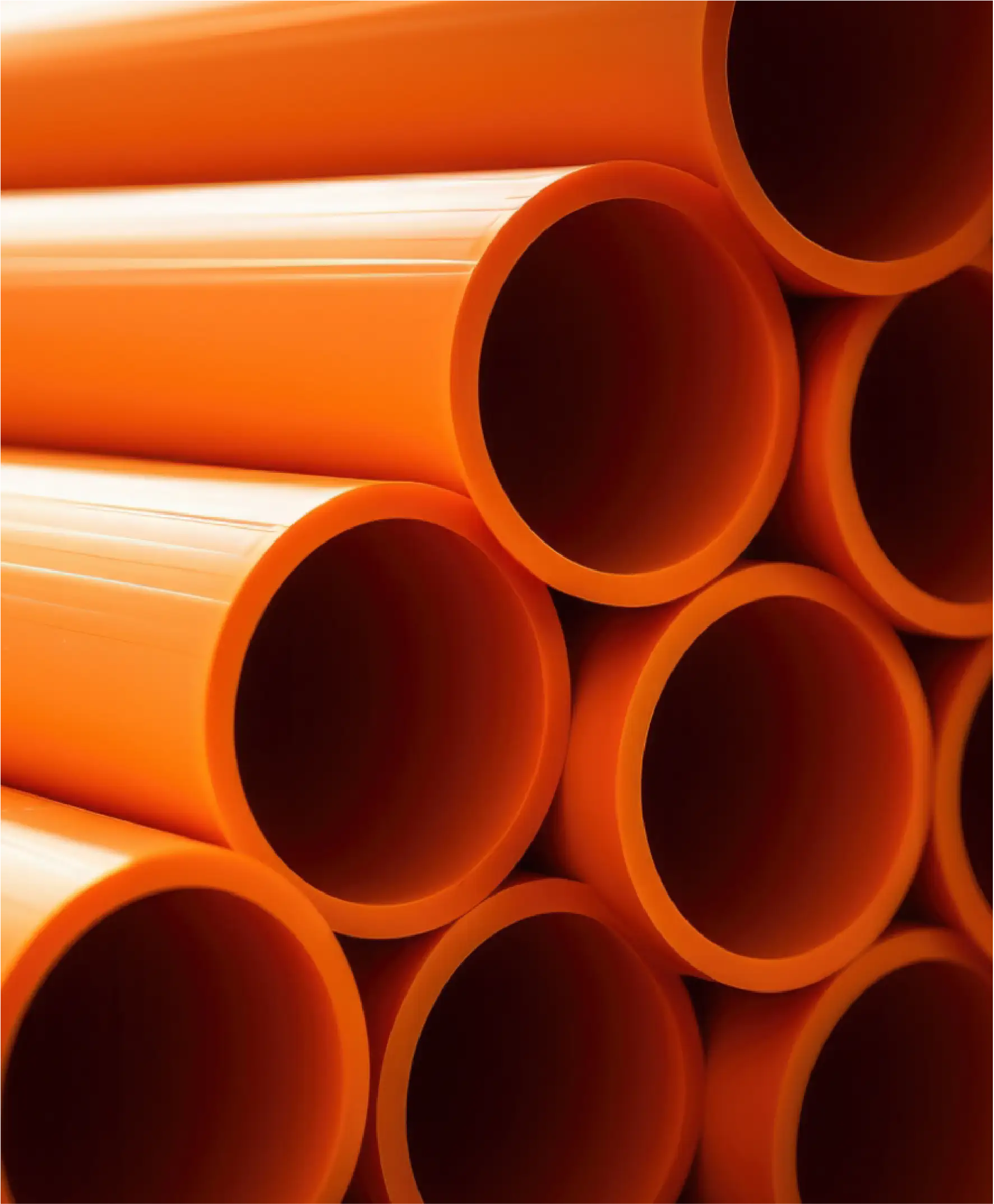 Orange sewer pipes in a stack.