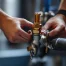 Plumber inspecting a gas line in a house.